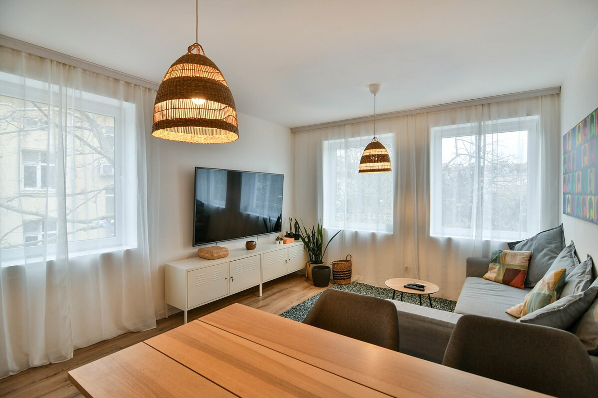 A sleek and modern kitchen with black tile backsplash, open shelves, and all essential appliances, including a stove, oven, and coffee maker, perfect for preparing delicious home-cooked meals during your stay.