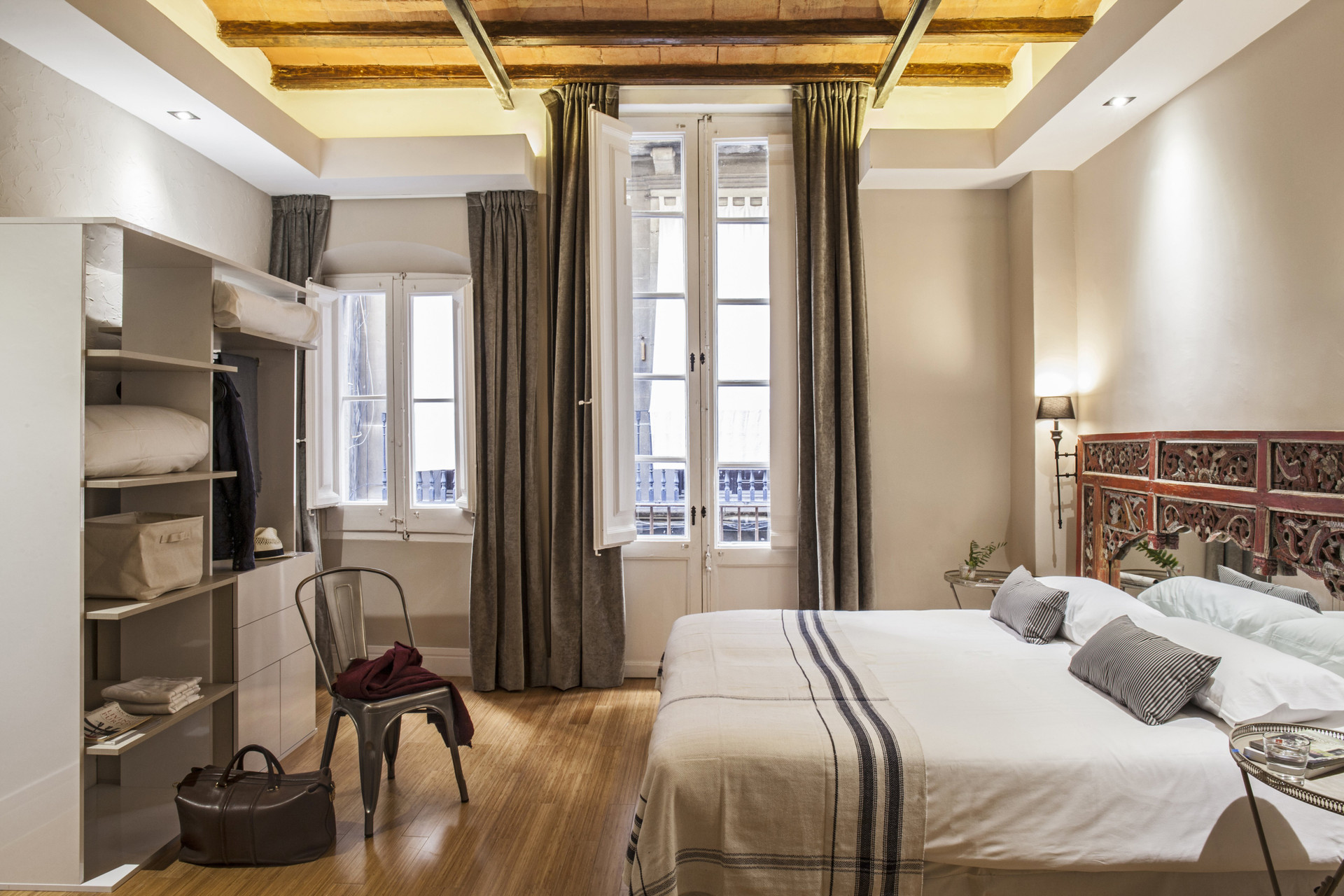 Bright bedroom with ornate headboard