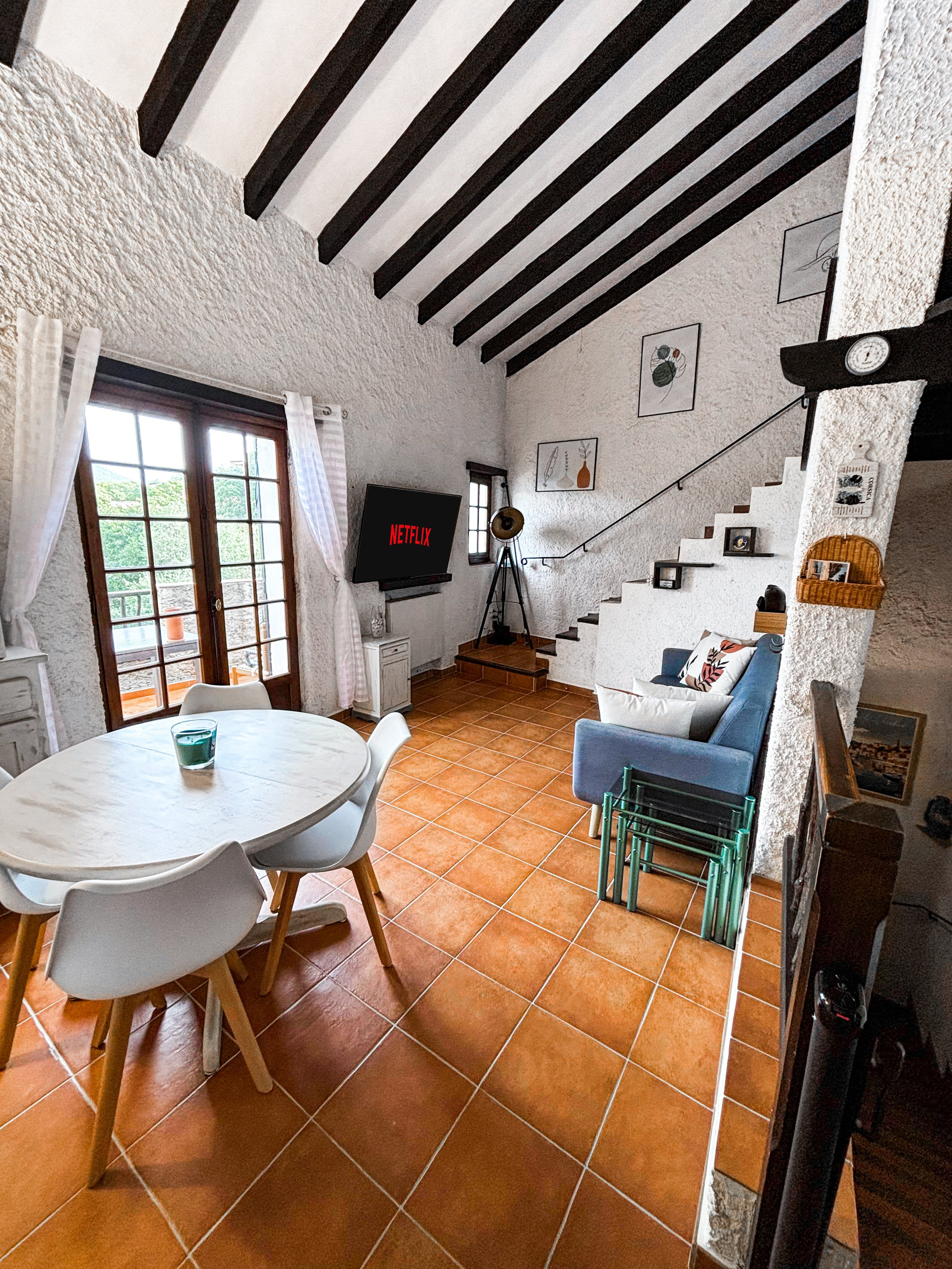 Living dining area exposed beams TV
