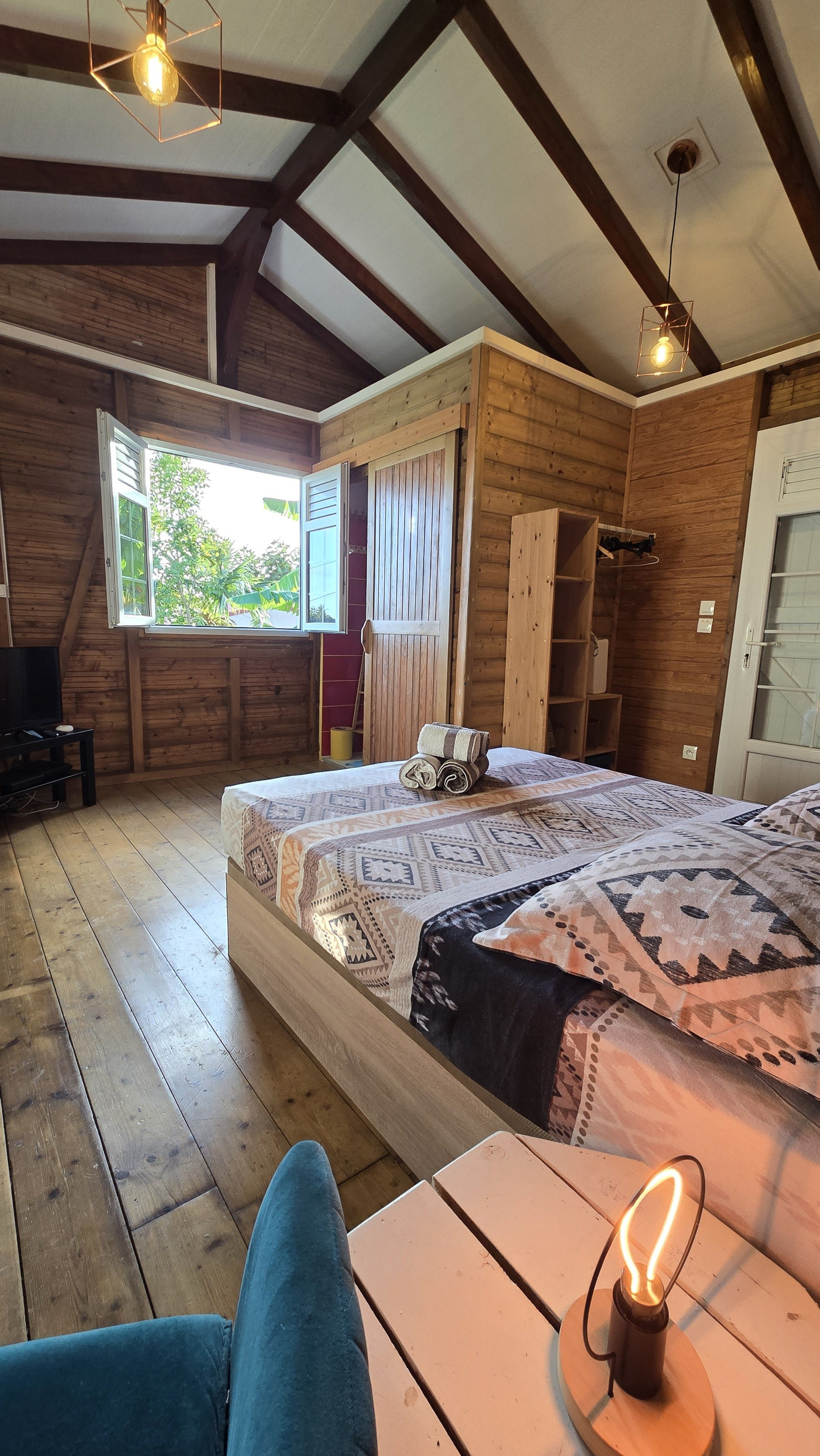 Spacious bedroom with large window and garden view