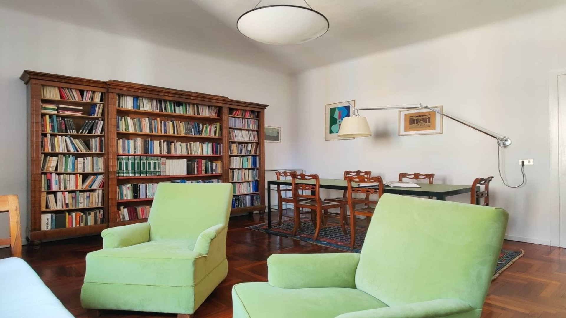Dining table for six, Persian rug, original art. The room opens up