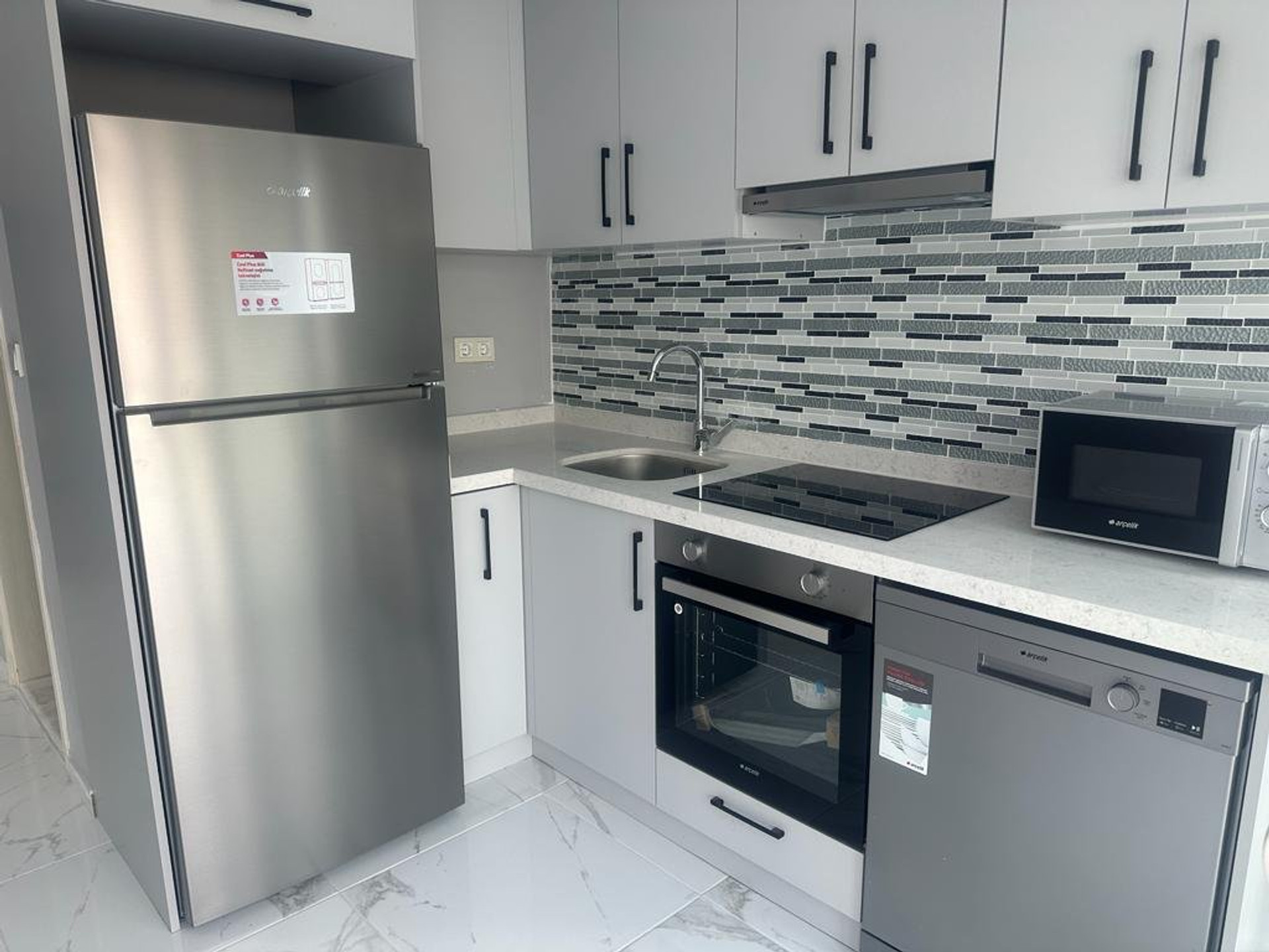 Compact kitchen with appliances and sink