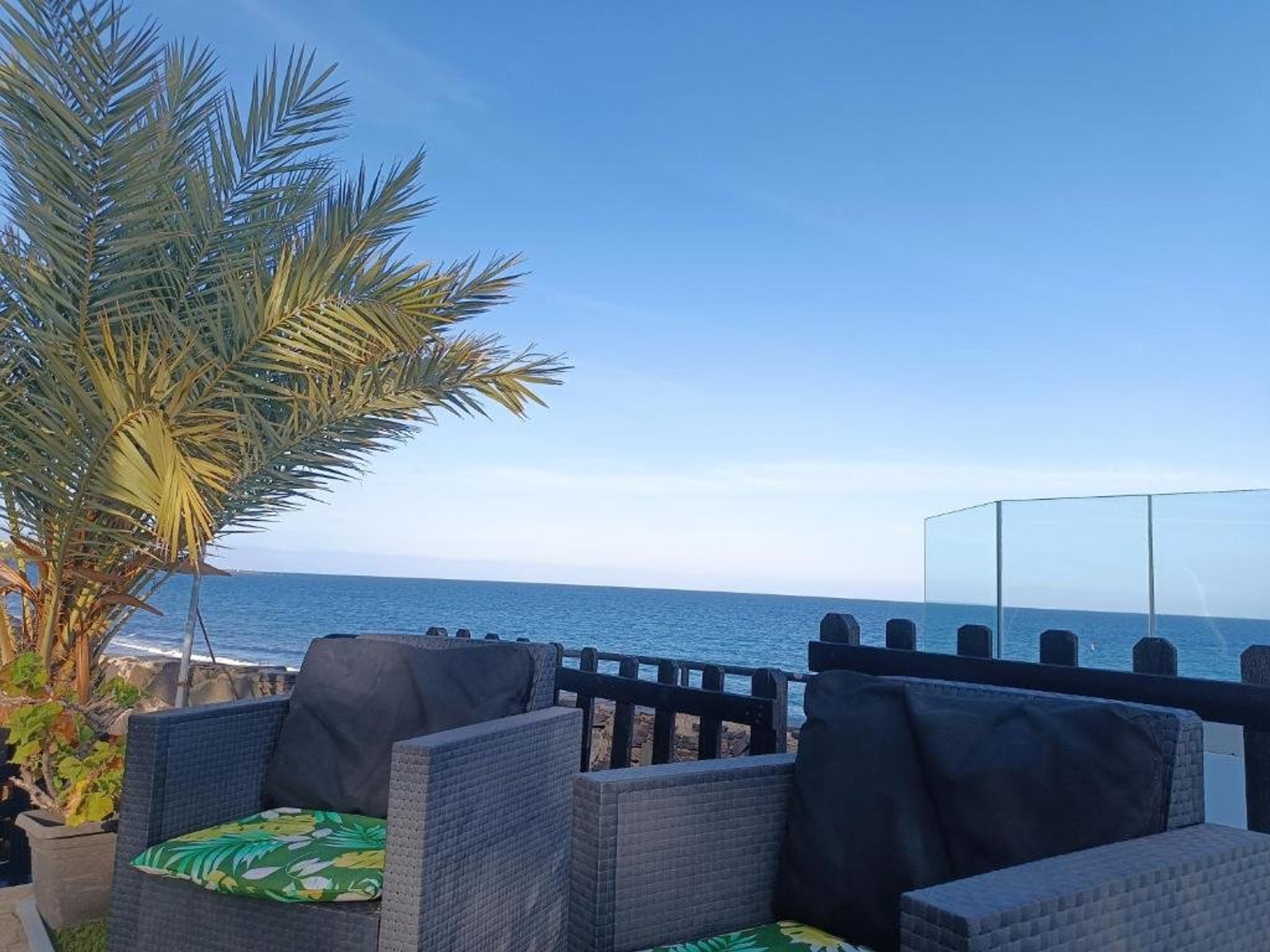 Seafront terrace with rattan seating