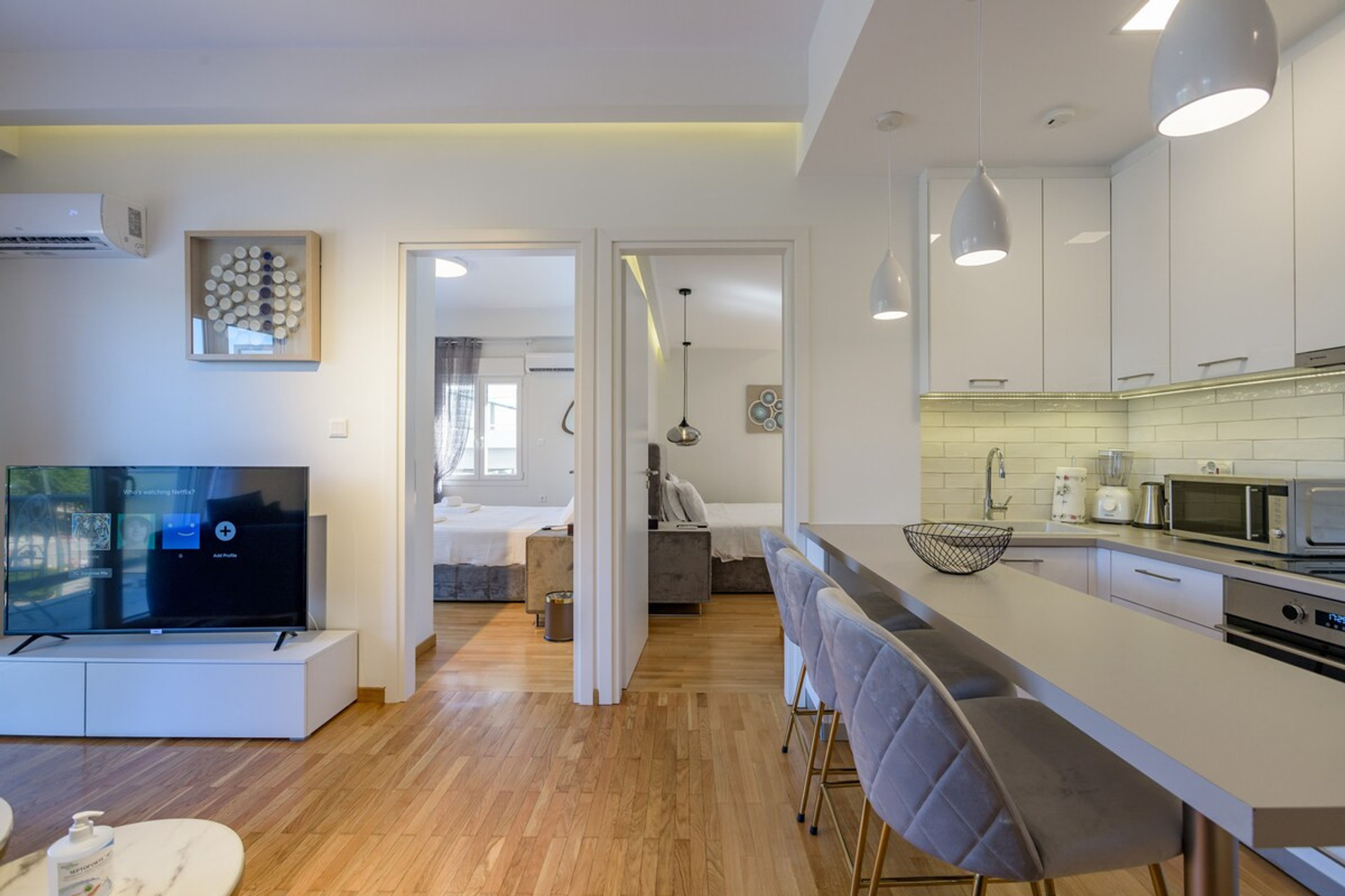 Bright and modern open-plan living space featuring a fully equipped kitchen, cosy dining area, and a stylish lounge with a flat-screen TV. Natural light flows beautifully, creating a warm and inviting atmosphere. Perfect for relaxing or entertaining!