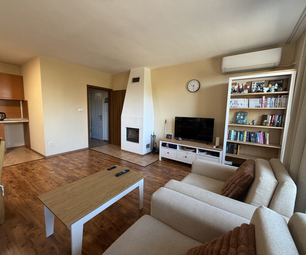 Living room with fireplace and TV