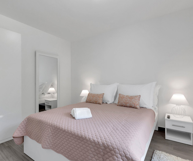 Bright bedroom with pink bedspread