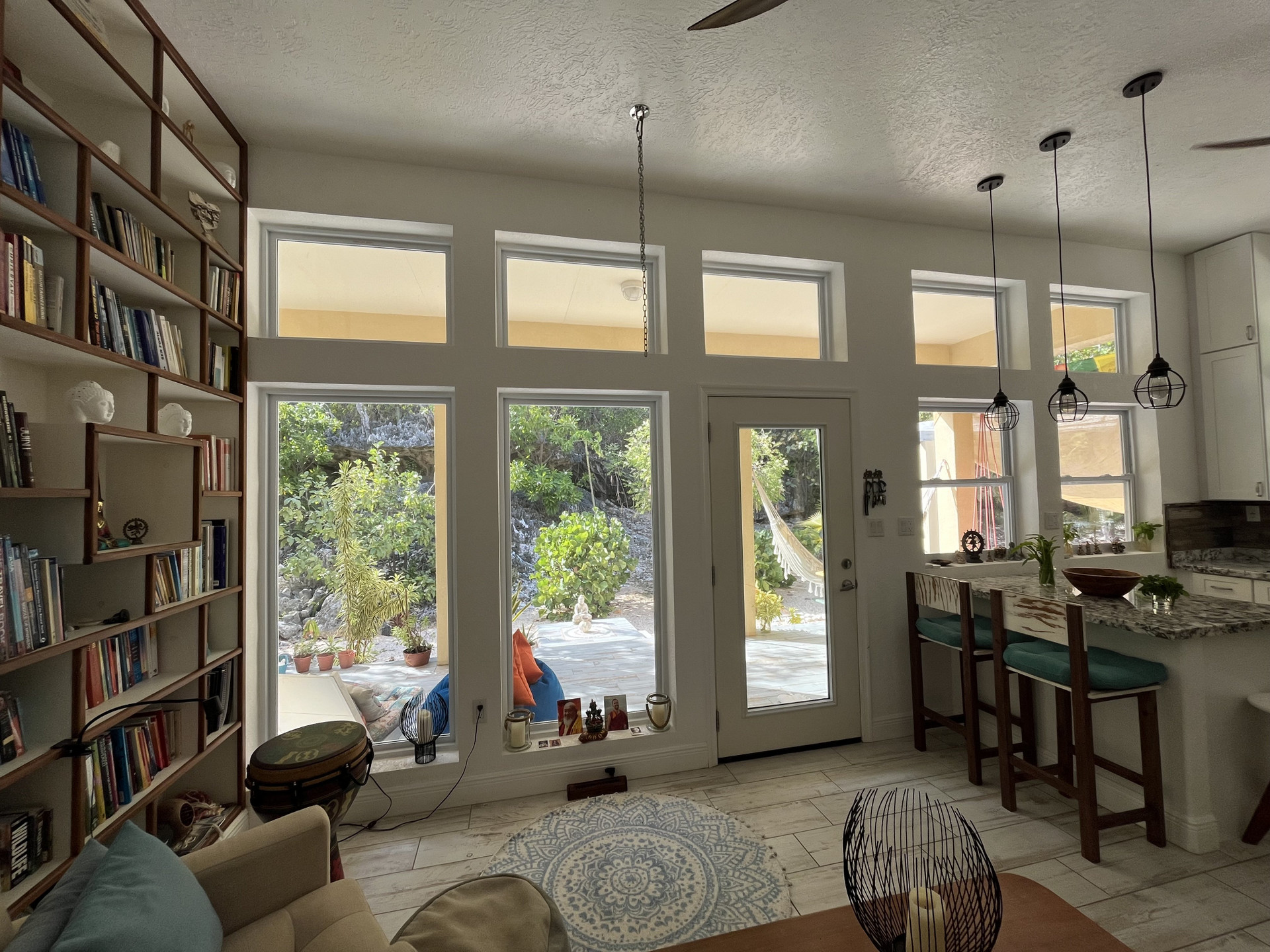 Bright living room with bookshelf kitchen