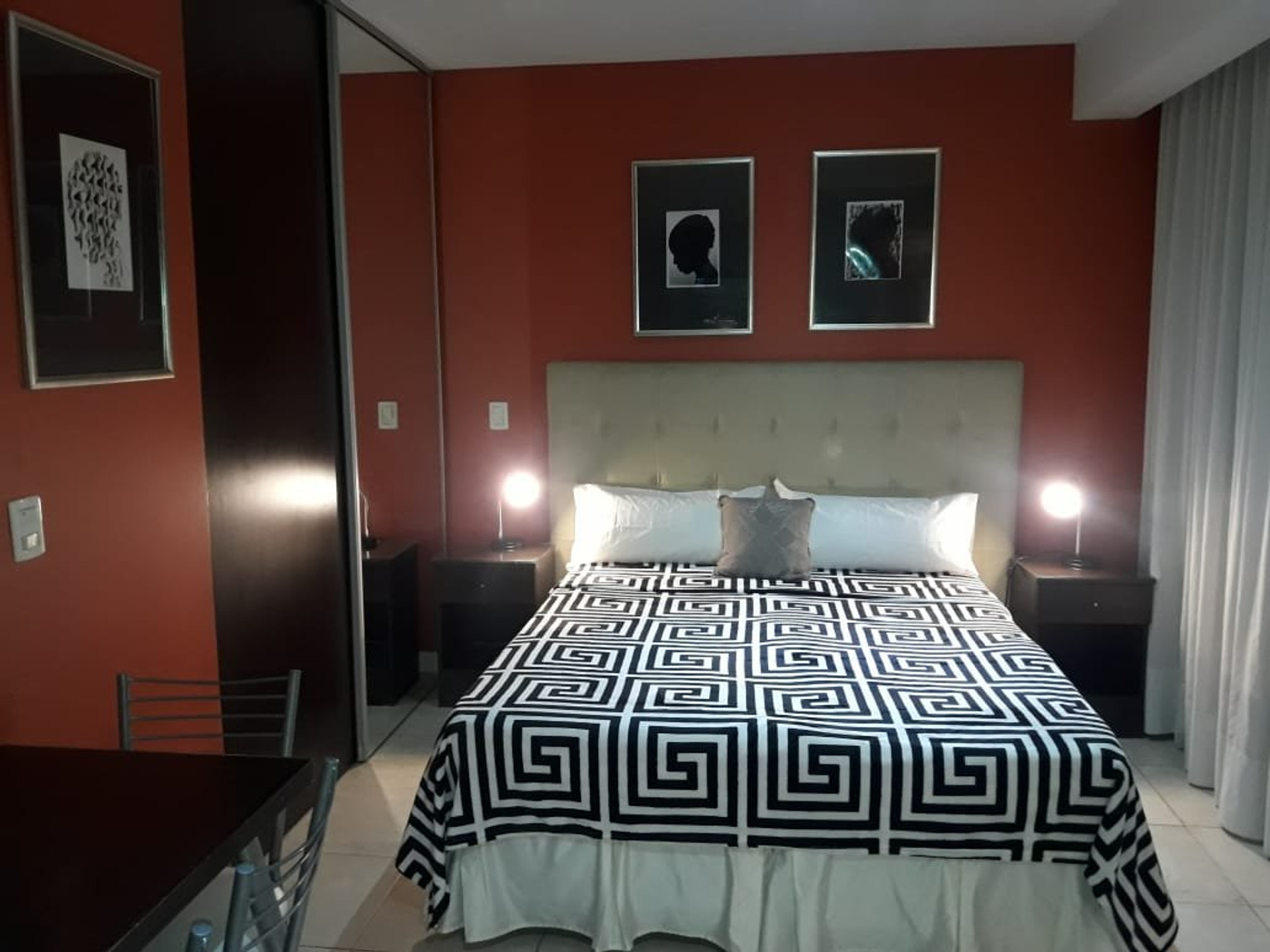 Double bed with red accent wall