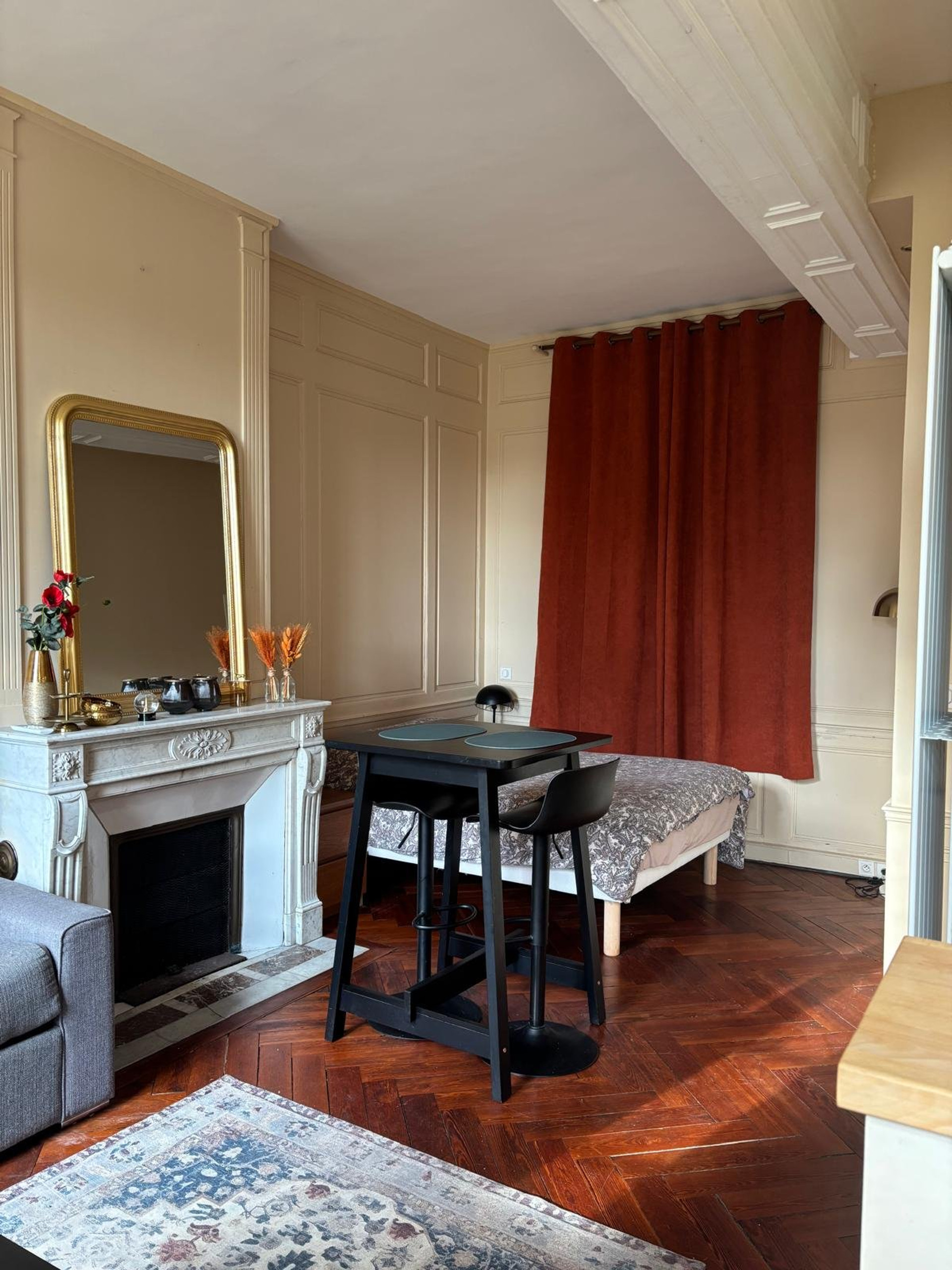Living area with fireplace and mirror