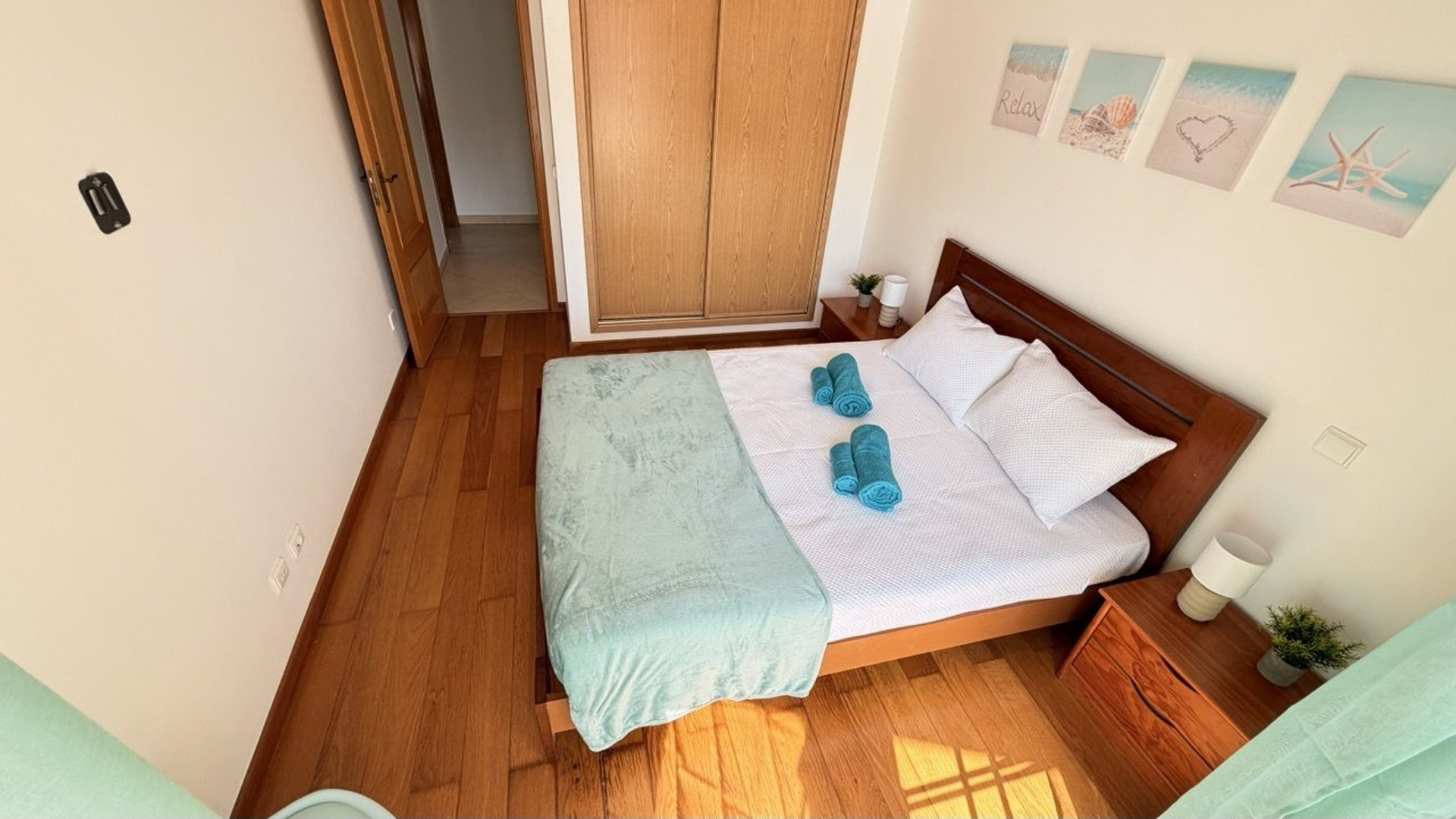 Bedroom with double bed towels