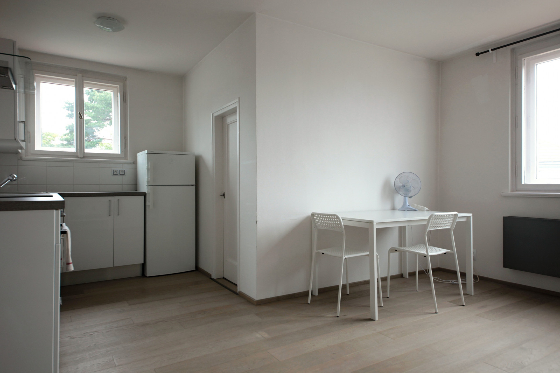 Dining area with kitchen and windows