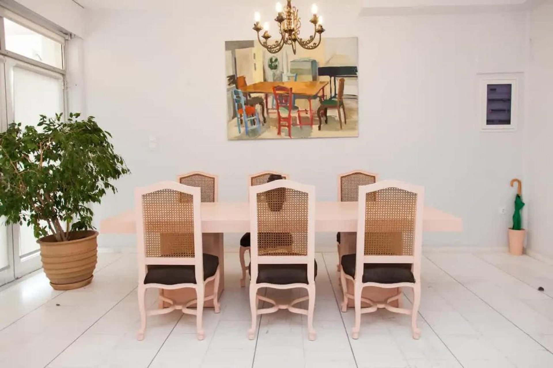 Dining table seats up to 10 people with natural plant and greek oil painting