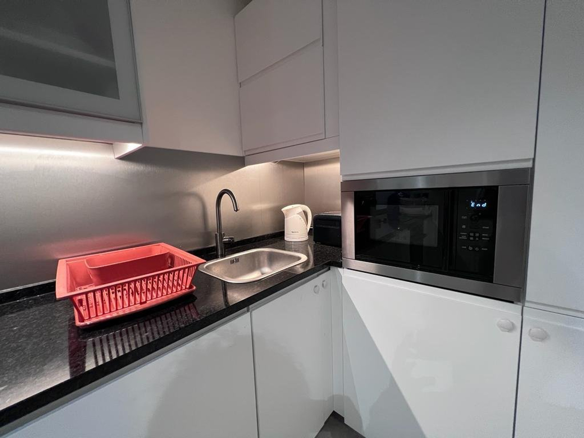 Kitchen with sink and microwave