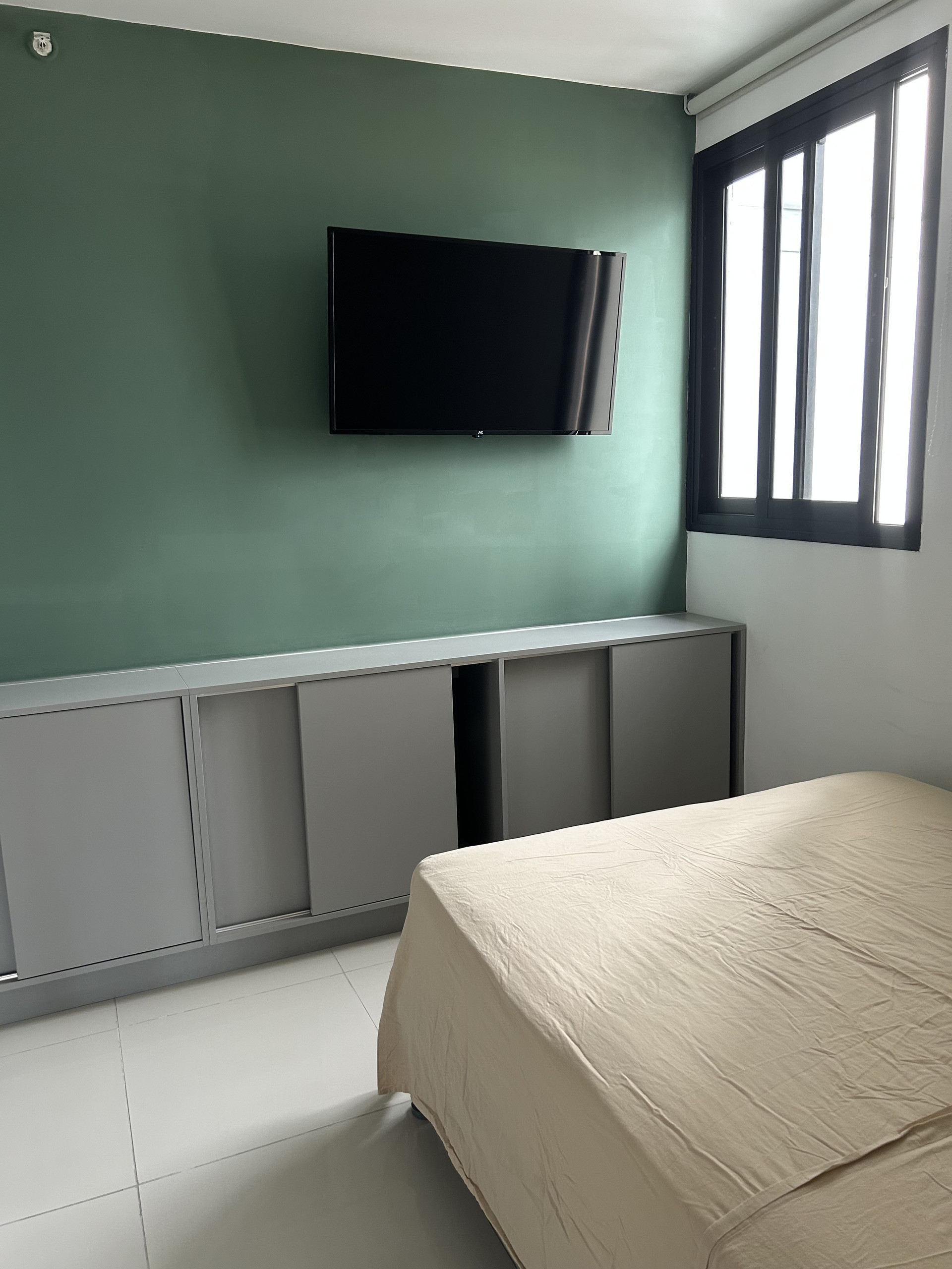 Bedroom with green wall TV