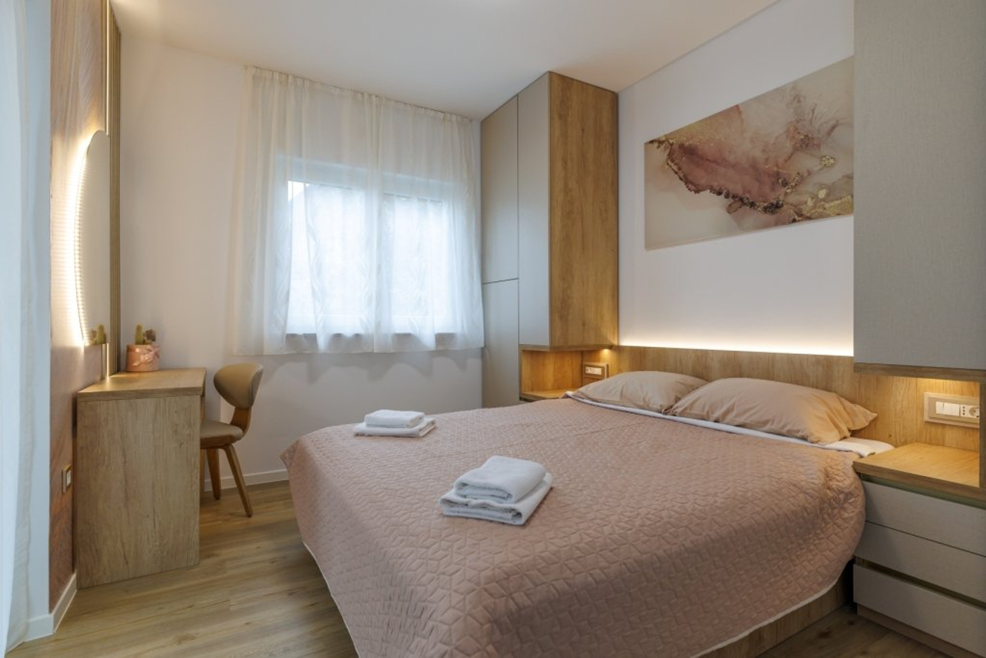 Second bedroom with beige bedding