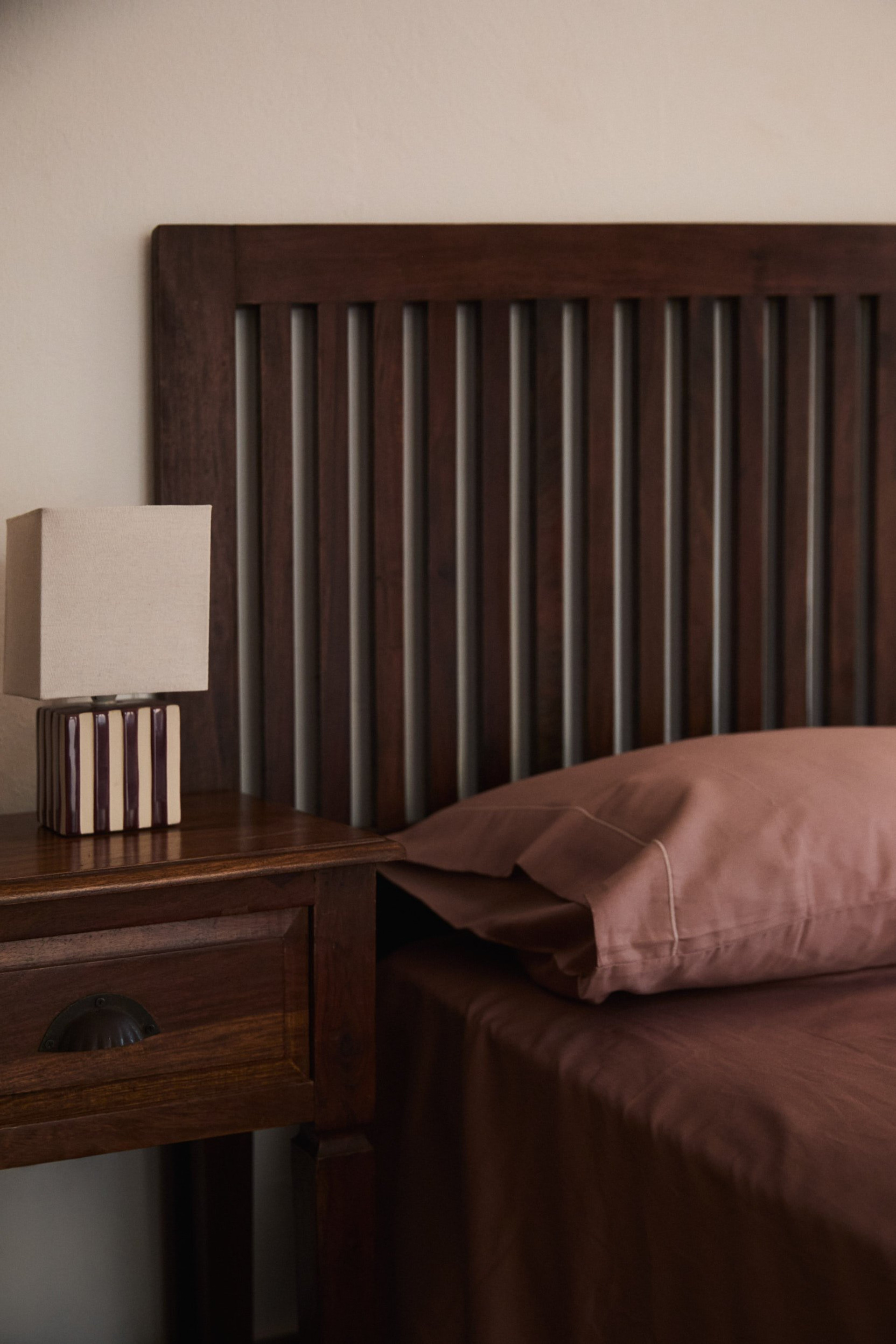 Wooden bed headboard nightstand detail